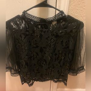 Black lace top with back zipper and sheer sleeves.